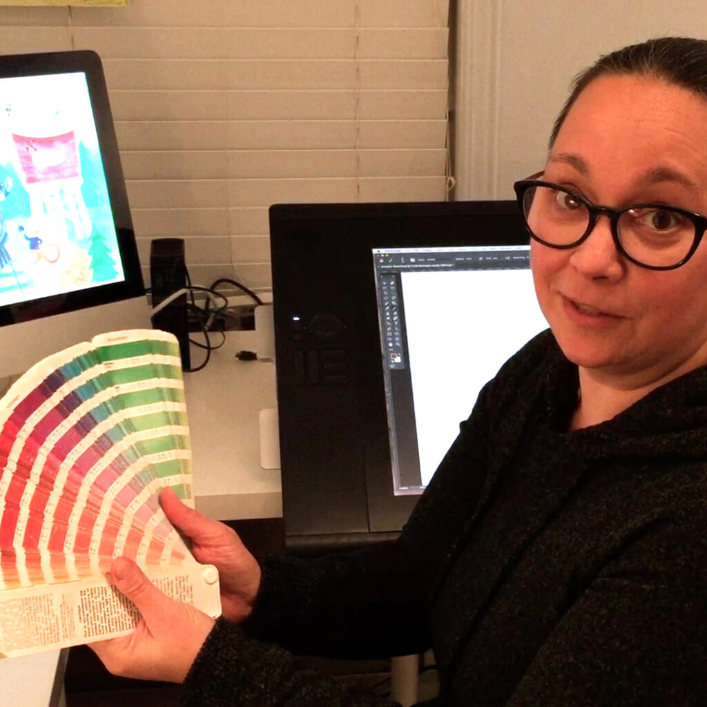 Isabelle Charbonneau dans son bureau devant son ordinateur qui montre une palette de couleur.